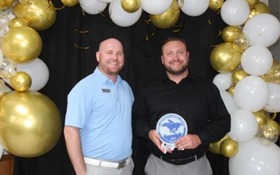Gothenburg Chamber of Commerce President Tony Collins presented the Pony Express Rider award to Joe Libal (right). Joe is a vice president of lending at the bank. 